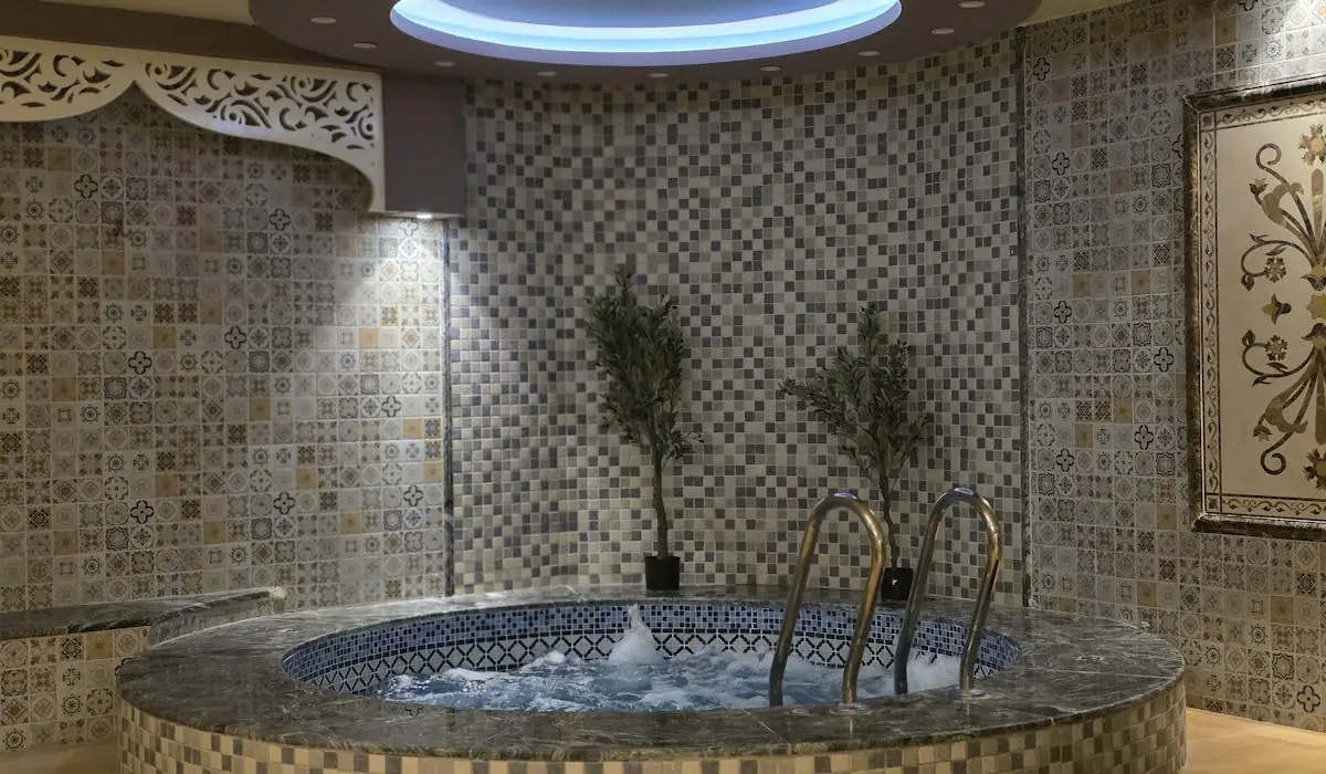 Ornate mosaic tile spa room — wet area tile installation